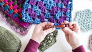 Tackle the iconic granny stitch and granny square as you create a stylish hooded vest.